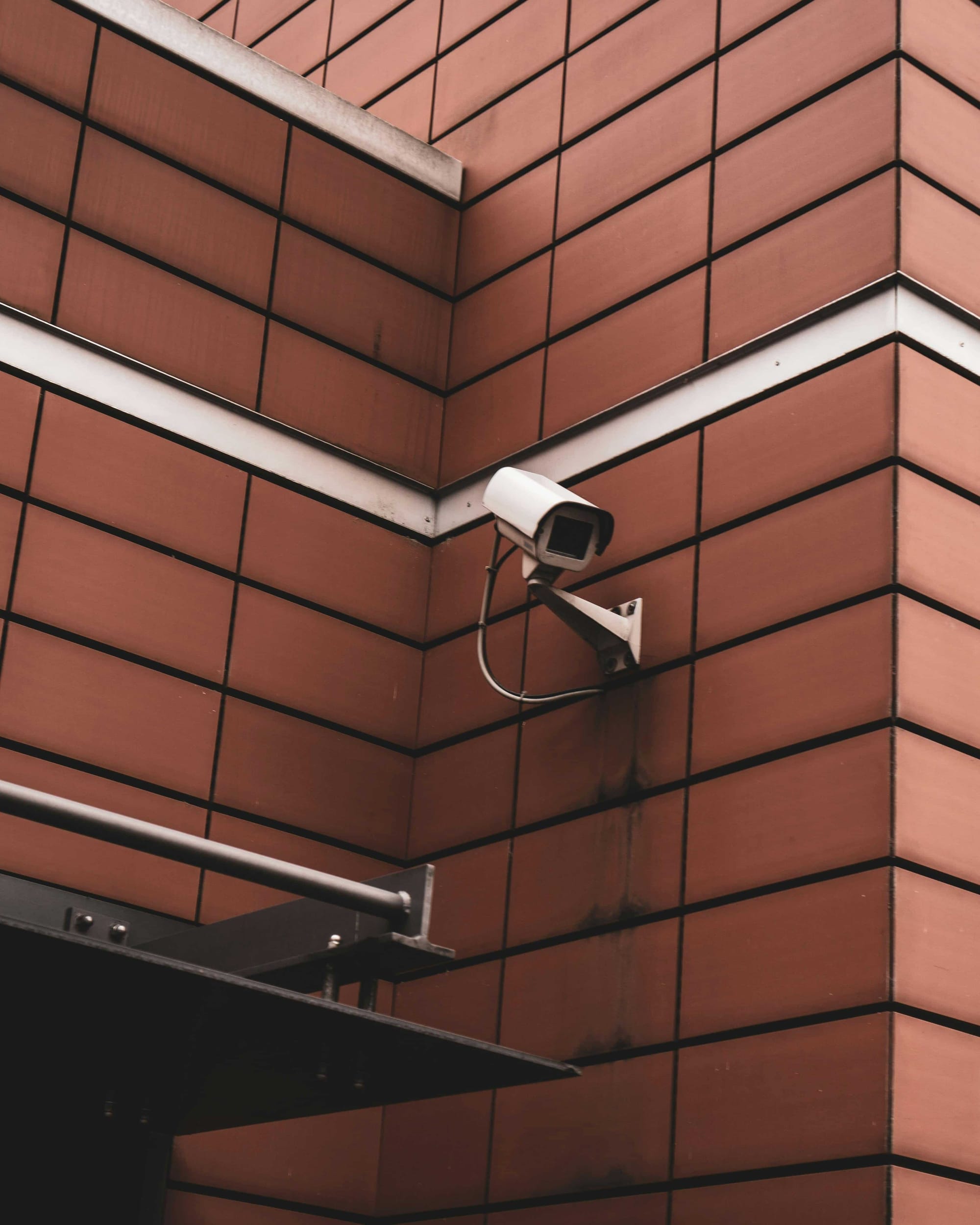 Wall-mounted CCTV camera on a brick building, symbolizing safety upgrades and crime prevention efforts in Samdeok-dong Rodeo Alley, Daegu